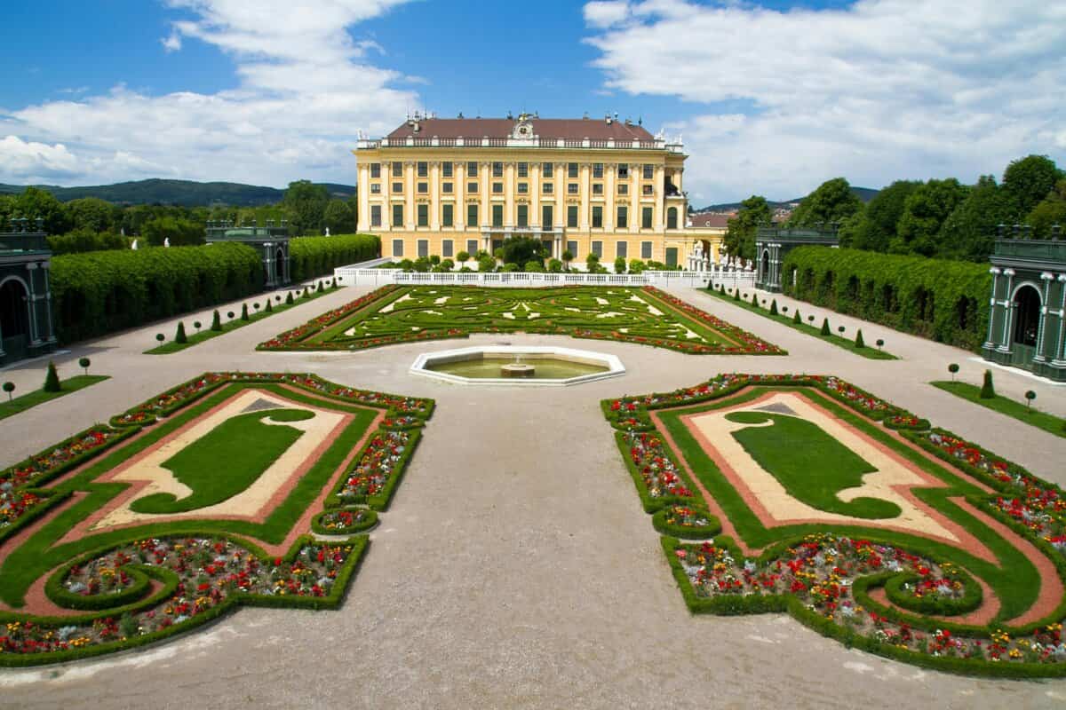 Elegant palace with ornate garden in foreground
